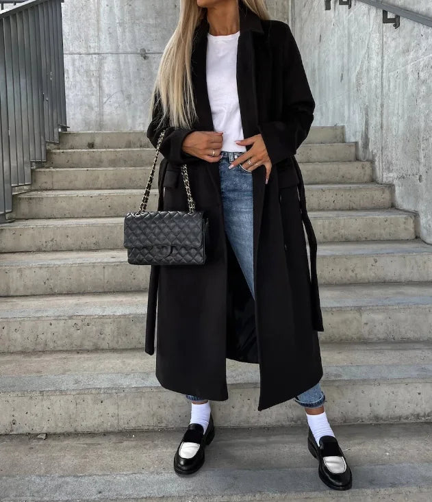 Women's long belted double-breasted coat with notched lapels and flap pockets