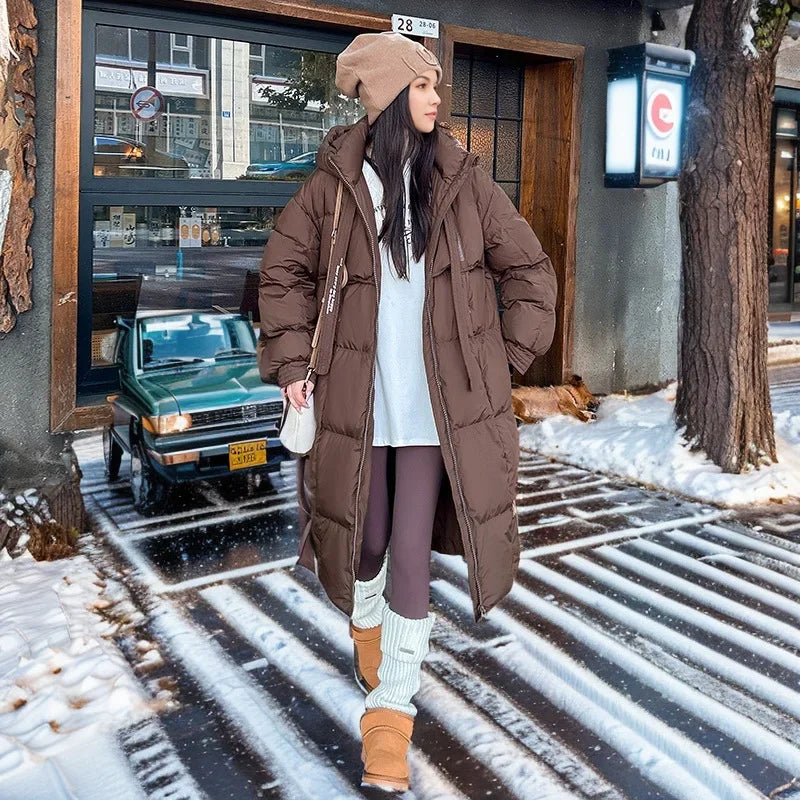 Women's long hooded quilted puffer coat with oversized fit and zip front