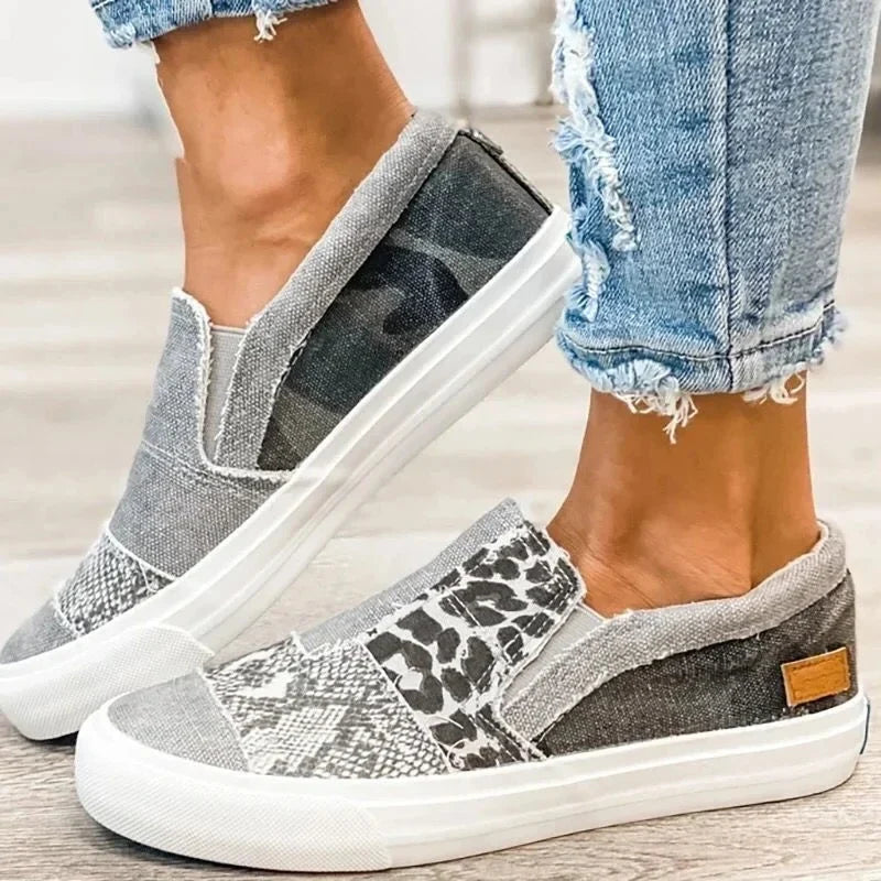 Women's patterned slip-on loafers with animal-print panels and flat white soles