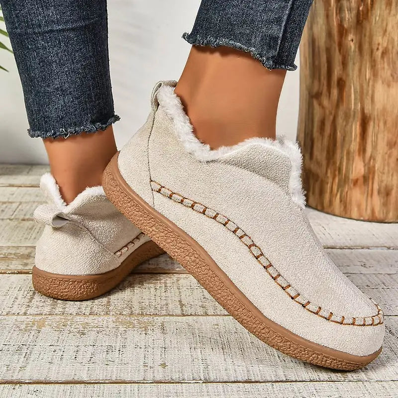 Women's slip-on loafers with moc toe stitching, plush trim and flat textured soles