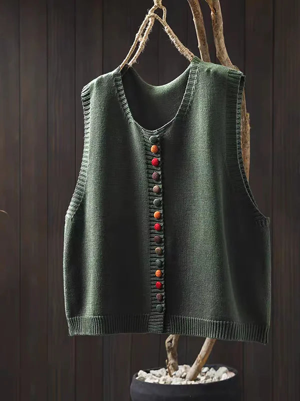 Women's sleeveless button-front cardigan vest with multicoloured buttons over a white blouse