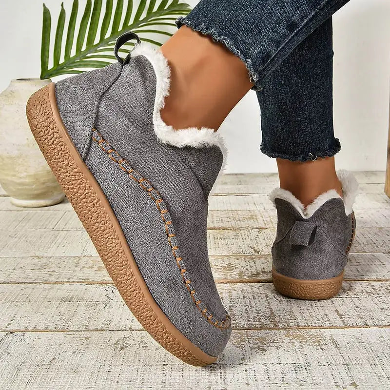 Women's slip-on loafers with moc toe stitching, plush trim and flat textured soles