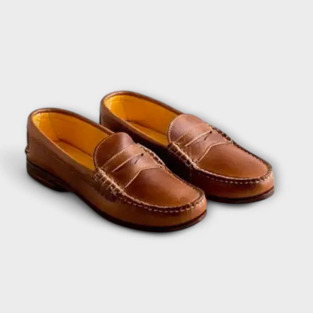 Unisex penny loafers with rounded toes, low heels and stitched vamp details