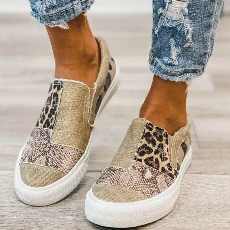 Women's patterned slip-on loafers with animal-print panels and flat white soles