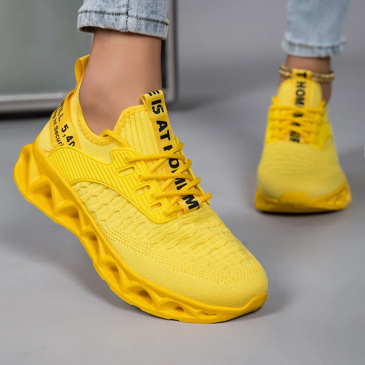 Women's lace-up trainers with textured upper and sculpted flat sole