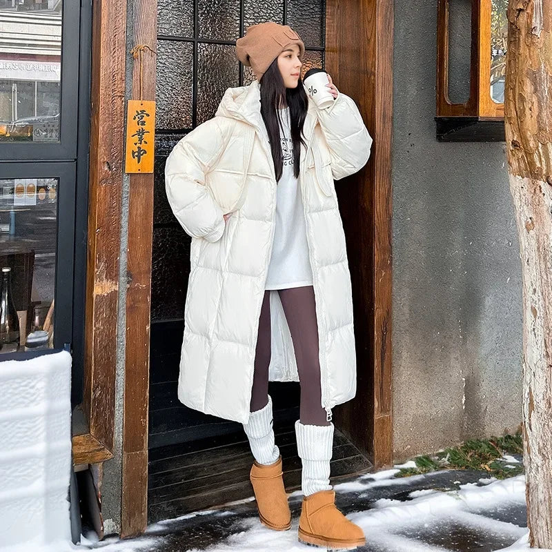 Women's long hooded quilted puffer coat with oversized fit and zip front