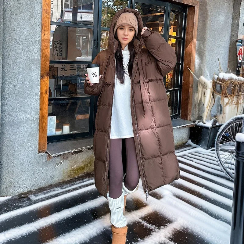 Women's long hooded quilted puffer coat with oversized fit and zip front