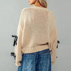 Women's chunky knit cardigan with contrasting bow ties and long sleeves