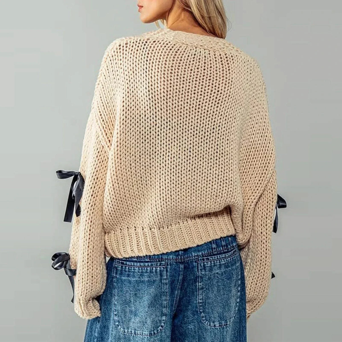 Women's chunky knit cardigan with contrasting bow ties and long sleeves