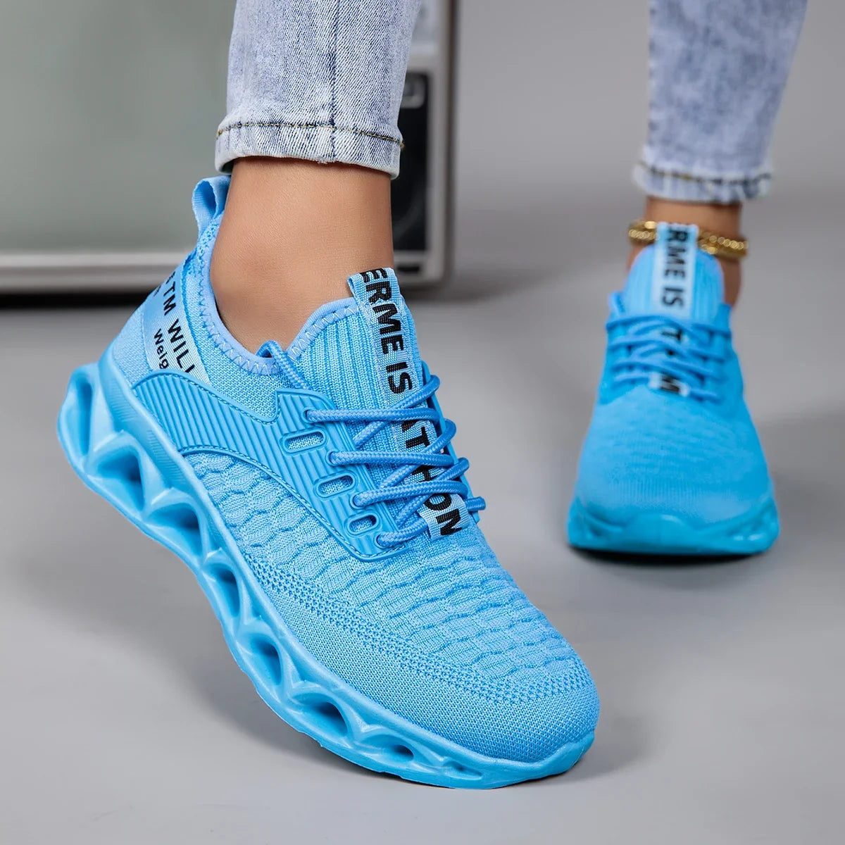 Women's lace-up trainers with textured upper and sculpted flat sole