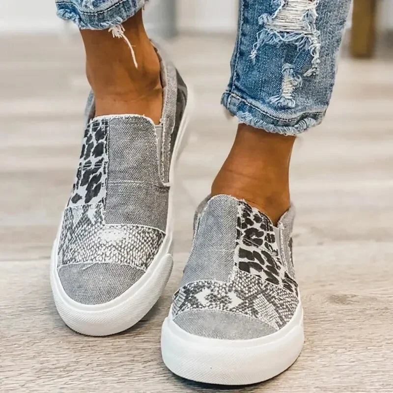 Women's patterned slip-on loafers with animal-print panels and flat white soles