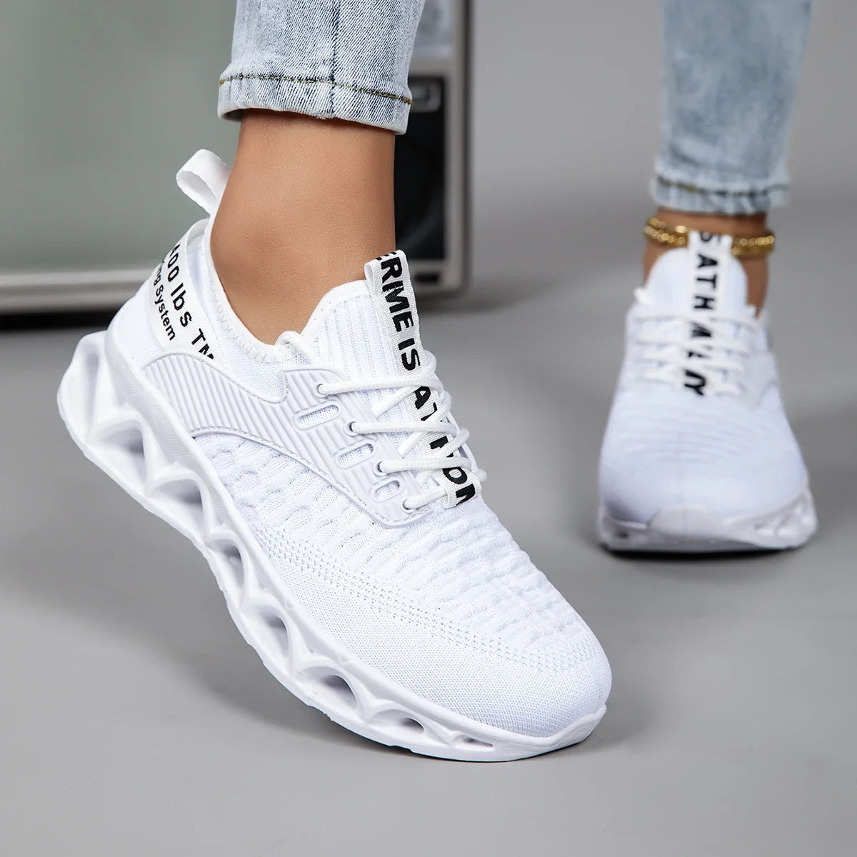 Women's lace-up trainers with textured upper and sculpted flat sole