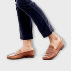 Unisex penny loafers with rounded toes, low heels and stitched vamp details