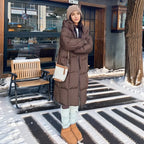 Women's long hooded quilted puffer coat with oversized fit and zip front