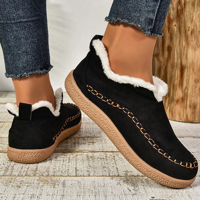Women's slip-on loafers with moc toe stitching, plush trim and flat textured soles