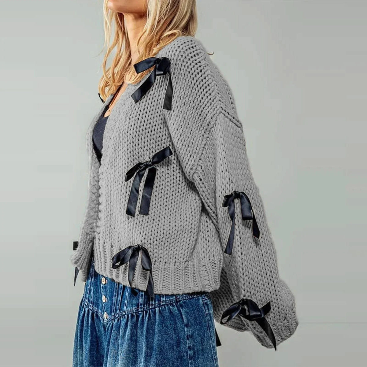 Women's chunky knit cardigan with contrasting bow ties and long sleeves
