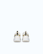 White women's trainers with gold mirror-effect side panels and chunky sole