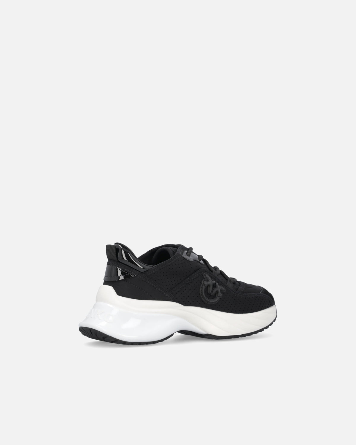 Black perforated trainers with lace-up fastening and white chunky sole