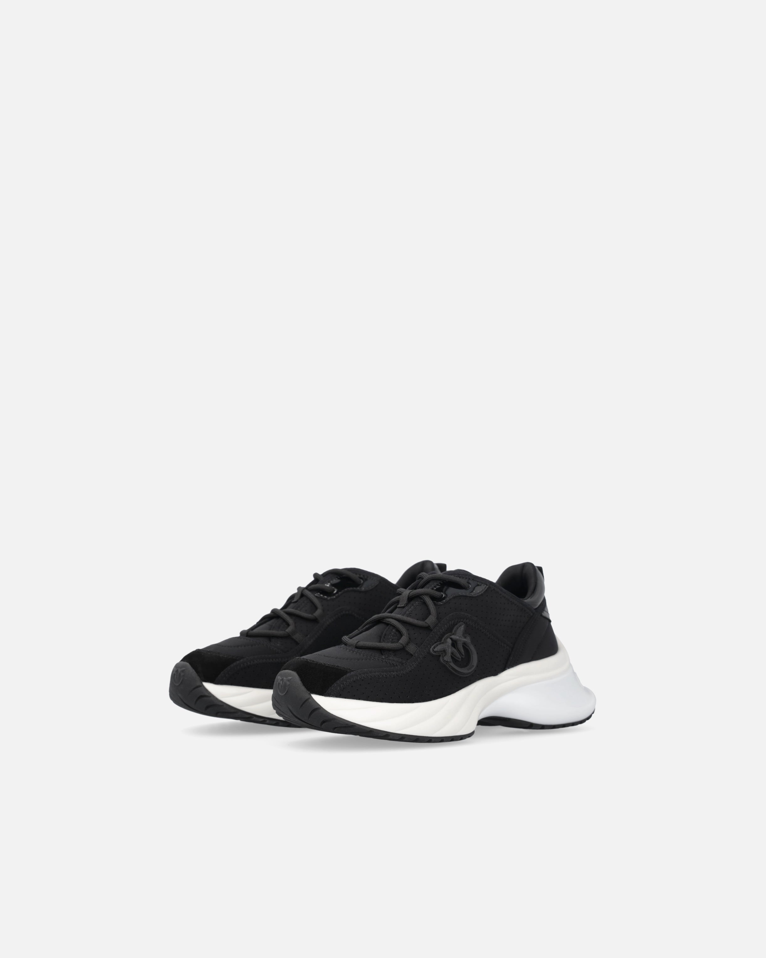 Black perforated trainers with lace-up fastening and white chunky sole