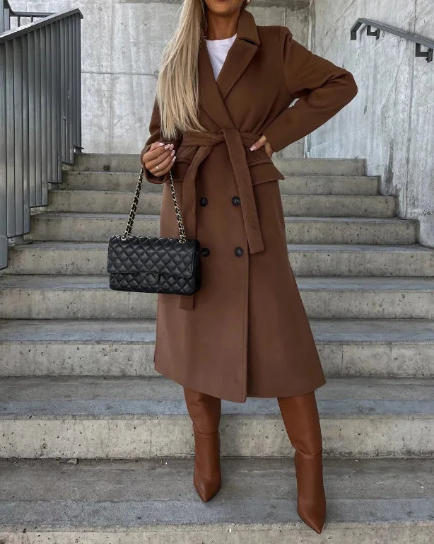 Women's long belted double-breasted coat with notched lapels and flap pockets