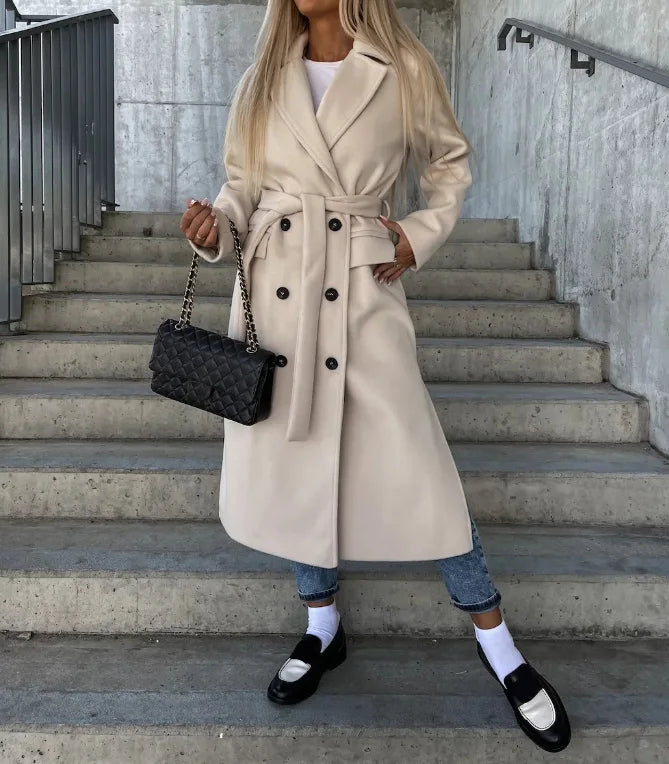 Women's long belted double-breasted coat with notched lapels and flap pockets