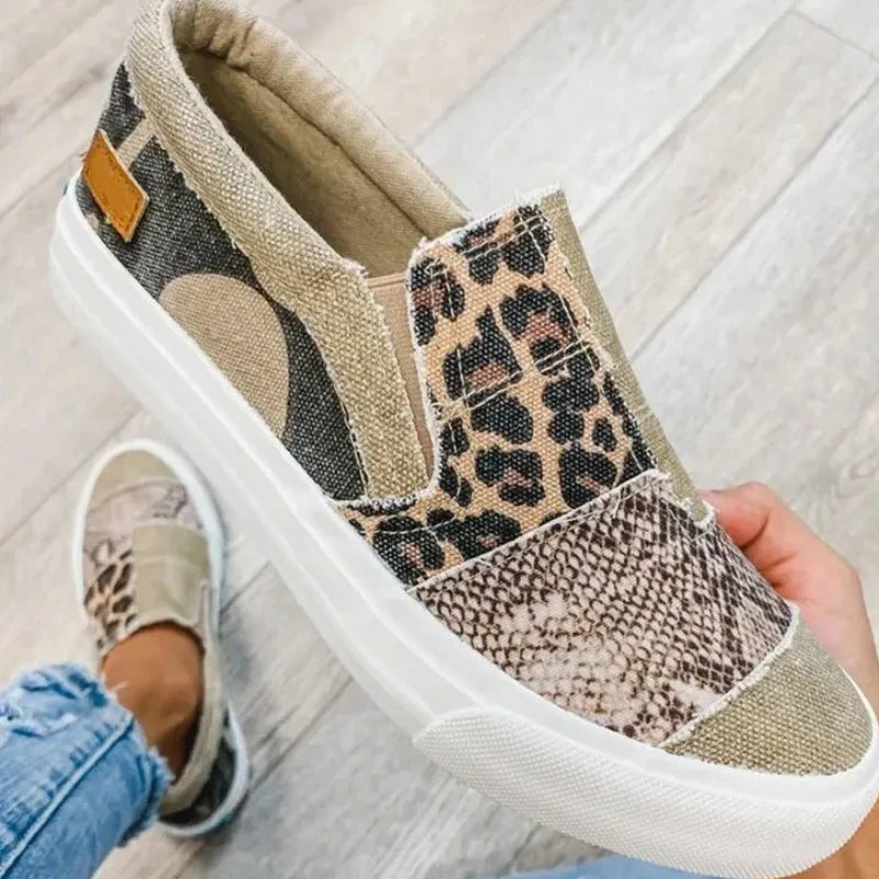 Women's patterned slip-on loafers with animal-print panels and flat white soles