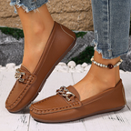 Women's flat slip-on loafers with moc toe stitching and decorative chain detail