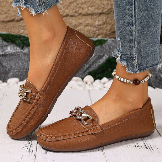 Women's flat slip-on loafers with moc toe stitching and decorative chain detail