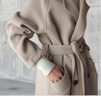 Women's long trench coat with notched lapels, buttons and side pockets