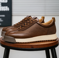 Low-top lace-up trainers with textured side panels and flat soles