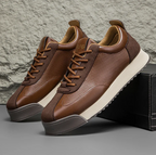 Low-top lace-up trainers with textured side panels and flat soles