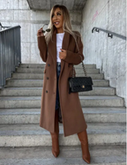 Women's long belted double-breasted coat with notched lapels and flap pockets
