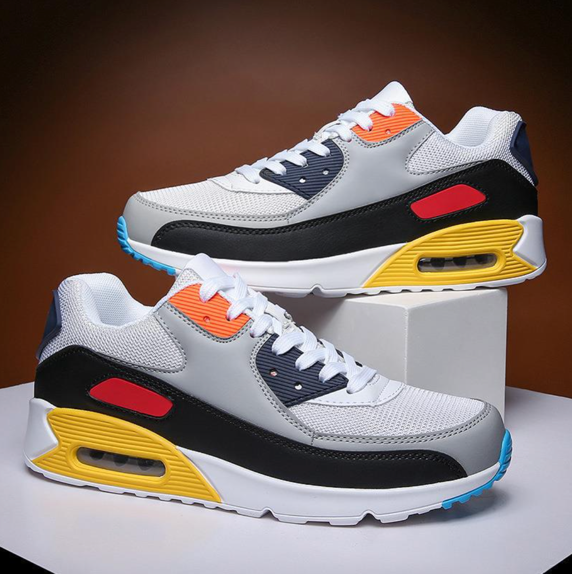 Low-top lace-up air cushion trainers with layered panels and visible air-style sole window