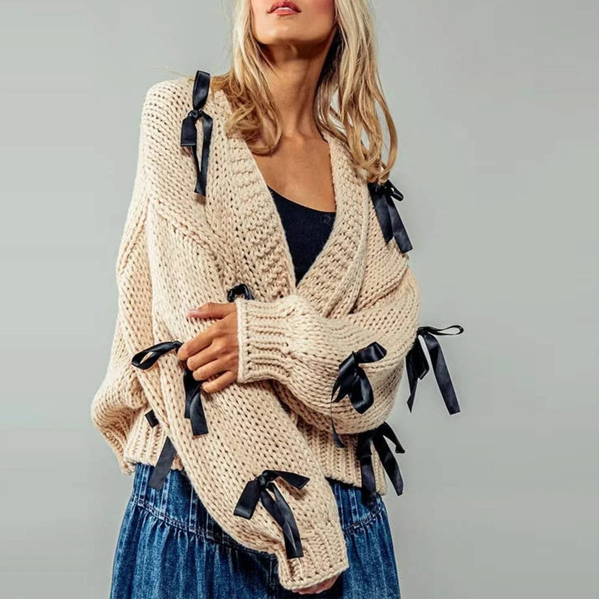 Women's chunky knit cardigan with contrasting bow ties and long sleeves