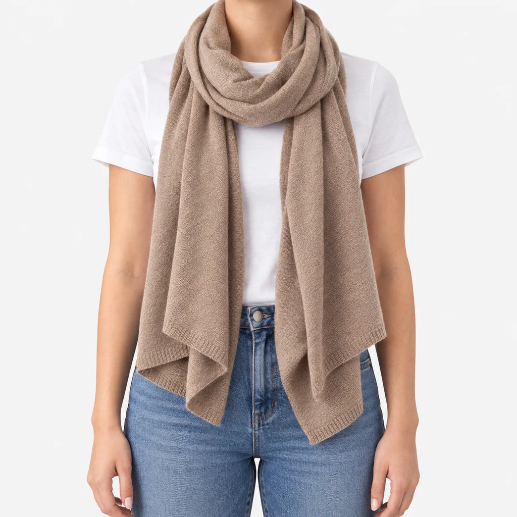 Women's long plain scarf with ribbed edges worn in a draped wrap
