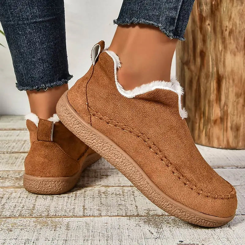 Women's slip-on loafers with moc toe stitching, plush trim and flat textured soles