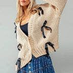 Women's chunky knit cardigan with contrasting bow ties and long sleeves