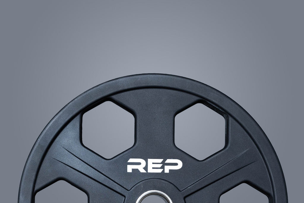 Black circular Olympic weight plate with six grip holes and 45 marking