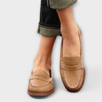 Unisex penny loafers with rounded toes, low heels and stitched vamp details
