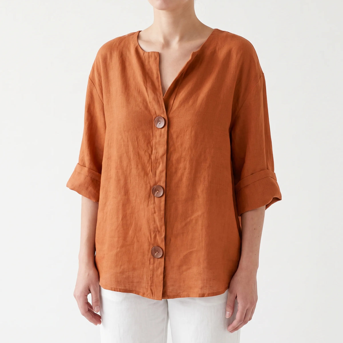 Women's orange V-neck button-down blouse with rolled three-quarter sleeves