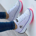 Women's low-top lace-up trainers with panelled uppers, side patches and flat ridged soles