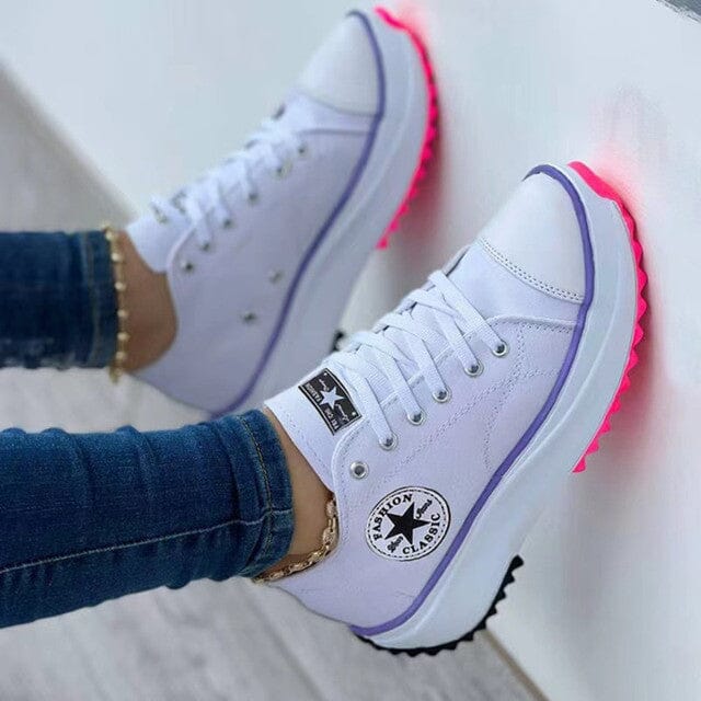Women's low-top lace-up trainers with panelled uppers, side patches and flat ridged soles