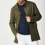 Green men's short trench coat with long sleeves, button front and flap pockets