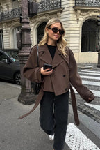 Women's brown cropped jacket with lapels, buttons and long belt