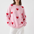 Women's oversized knitted jumper with raised red heart motifs and long sleeves