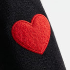 Women's oversized knitted jumper with raised red heart motifs and long sleeves