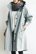 Women's long hooded raincoat with button front, side pockets and elasticated cuffs