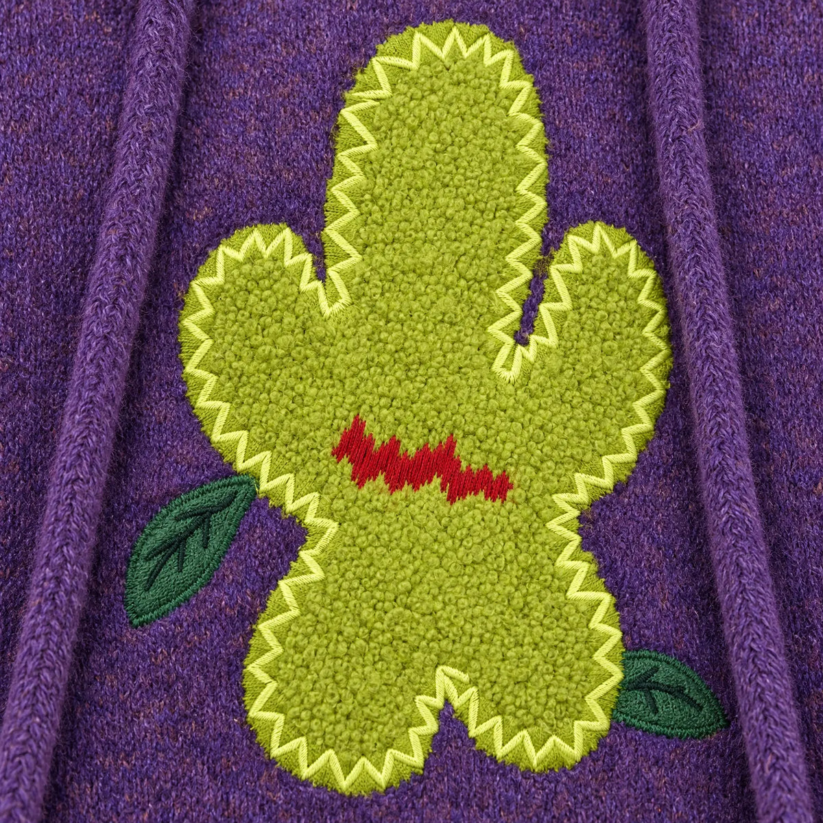 Women's purple knitted hoodie with a large cactus graphic and hood