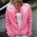 Women's pink knitted cardigan with floral yoke and button front