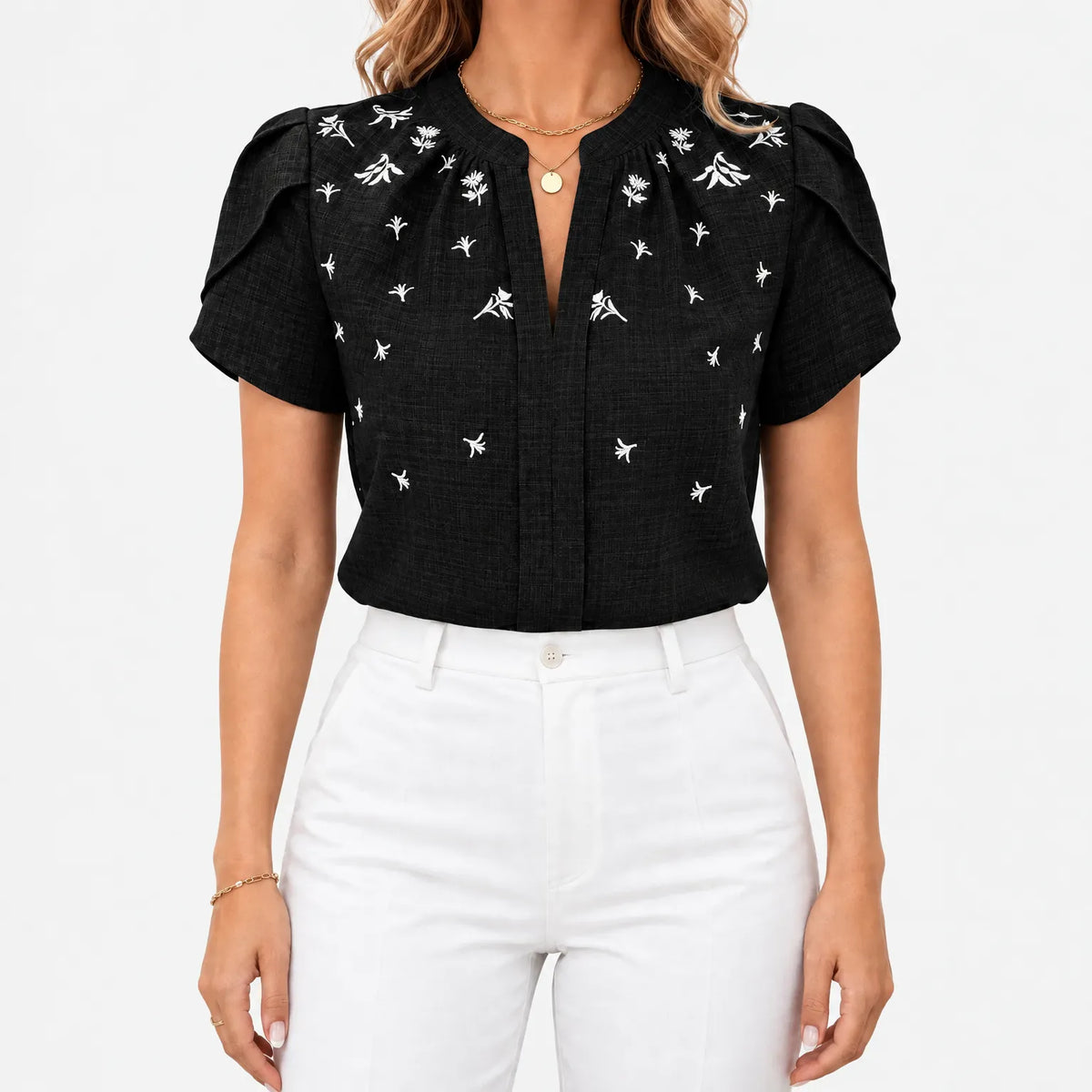 Women's short sleeve blouse with white botanical print and V-neckline